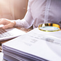 Investigating Corporate Tax Fraud Investigating Corporate Tax Fraud. Commercial Auditor Using Magnifying Electronic