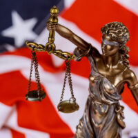United States of America in Law and Justice statue of Lady Justice with USA flag