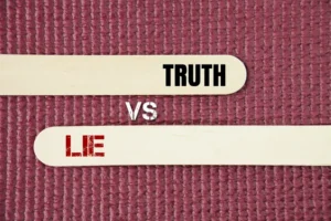 A stick with two opposite words truth vs lie. Truth is a statement that aligns with reality, while a lie is a false statement made with the intent to deceive.